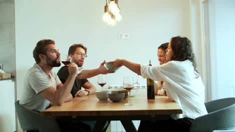 Slow-motion-shot-of-friends-talking-while-drinking-red-wine